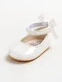 Close-up of white patent leather baby princess shoe with pearl strap and bow detail - 12cm/EUR19 / Glossy White