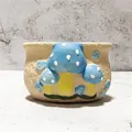Close-up of a hand-painted blue mushroom pattern on a rustic ceramic succulent pot. - Blue Mushroom Style (R)