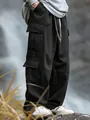Detailed view of black men's cargo pants featuring multi-pocket design and loose fit. - S / Black
