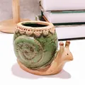 Detailed macro view of a cute snail-shaped ceramic succulent planter with green shell - Large Snail / 11x7x9.5cm