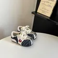 Close-up of children's silver and denim patchwork German Army Trainer style sneakers. - 16 / Blue Silver