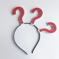 Detail view of a black headband featuring three iconic red felt question mark decorations - Red Question Mark Headband / Red