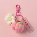 Macro detail of a handmade crocheted peach and flower keychain with a pink gift tag - Pink Clasp Single / Peach and Flower with Pink Clasp