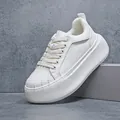 Close-up of white thick sole shell toe sneakers showing leather texture details - 42 / White