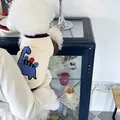 Detailed view of cream pet sweatshirt with blue dinosaur graphic on a small white dog - S / Dinosaur