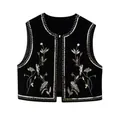 Detail view of a black velvet vest featuring intricate gold embroidery and sequins - XS / Tops / Black