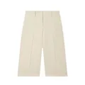 Detailed view of cream wide-leg shorts with hidden button closure and front pleats - XS / Bottoms / White