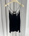 Close-up detail of a black rhinestone slip dress featuring delicate lace trim and cross straps - XS / Dresses / Black