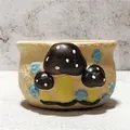Detail view of a creative hand-painted ceramic flower pot with 3D mushroom design - Orange Brown Mushroom Style (Q)