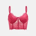Detailansicht eines rosa Spitzen-Bustiers mit Wimpernborte und Blumenmuster. - Fuchsia