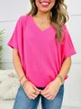 Close-up detail of bright pink V-neck ribbed knit short sleeve t-shirt for women - S / Tops / Bright Pink