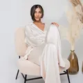 Elegant champagne satin pajama set for women presented in a cozy minimalist studio - S / Top And Bottom / Beige