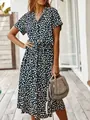 Close-up of a stylish navy polka dot dress with short sleeves and a belted waist for summer. - S / Dresses / Black