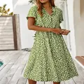 Detail of the green summer dress showing the button-down front and polka dot print - S / Dresses / Yellow-Green