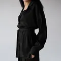 Close-up detail of luxurious black faux silk women's pajama set with waist belt - S / Top And Bottom / Black