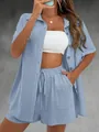 Detail of light blue textured fabric on women's short sleeve shirt and shorts set - Blue
