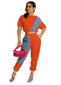 Full-body shot of a stylish orange denim patchwork two-piece crop top and joggers set - S / Top And Bottom / Orange
