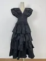 Detail view of black pleated multi-layered ruffle evening gown with a deep V-neckline - Black