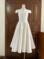Front view of white V-neck acetate cocktail dress with petal sleeves on mannequin - White