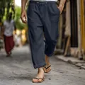Close-up of men's navy linen pants featuring elastic drawstring waist and side pockets. - S / Bottoms / Black