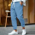 Detail view of men's blue cotton linen joggers with white drawstring and side pockets - Light Blue