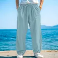 Close-up detail of men's loose light blue beach trousers featuring a drawstring waist. - S / Bottoms / Light Blue