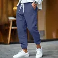 Detailed view of men's blue cotton linen joggers with drawstring waist and cuffed ankles - Navy Blue