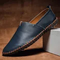 Detailed view of navy blue pebbled leather men's loafer with intricate brown hand-stitching - 38 / Loafers (955) / Blue