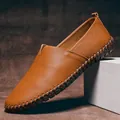 Macro view of brown pebble grain leather men's loafer with decorative stitching. - 38 / Loafers (955) / Brown