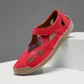 Close-up detail of red hollow leather sandal with handcrafted stitching and rubber sole - 38 / Red