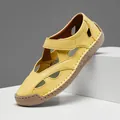 Detail shot of yellow hollow-out leather casual sandal for women on white display block - 38 / Yellow
