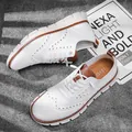 Detailed view of breathable white mesh casual shoes with stylish brogue patterns. - 40 / White