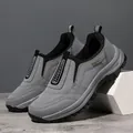 Macro view of grey men's outdoor sport shoes with thick black anti-slip rubber soles - 39 / Gray