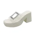 Side view of white platform sandal with clear strap and rhinestone buckle decoration. - 36 / White