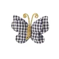 Detailed close-up of a fabric plaid butterfly hair clip with an elegant gold wire body. - Antenna Style / Black & White Check