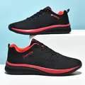 Side detail of breathable fly-knit sneakers in black and red with lace-up design. - 36 / Black Red