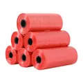 Detail view of a pyramid stack of six red pet waste bag rolls for waste collection - 15 Count Per Roll / Red