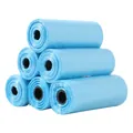 Macro detail view of light blue pet waste bags stacked neatly on a white background. - 15 Count Per Roll / Blue