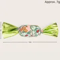 Candy-shaped catnip toy for cats featuring floral print fabric and green metallic ends - Green Floral Candy Toy