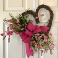 Close-up detail of a heart-shaped vine wreath with pink flowers and magenta burlap bow - Standard Style Heart Wreath (J3-41) / 45cm