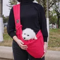 Close-up of a red pet sling carrier with a small white dog inside - Red (With Mesh)