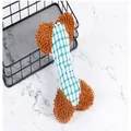 Detailed view of a bone-shaped plush dog toy with honeycomb mesh and soft brown shaggy ends. - Blue
