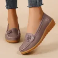 Close-up of mauve faux leather loafers with floral applique and white stitching details - Dusty Pink