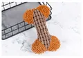 Close-up of a durable textured plush bone dog toy featuring corduroy and soft chenille fabrics - Coffee