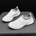 Breathable white knitted slip-on sneakers for women featuring a lightweight flexible sole. - 35 / White