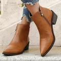 Detail view of brown pointed-toe ankle boots with side zipper and block heel. - 36 / Dark Brown
