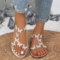 Silver flat sandals featuring sparkling rhinestone butterfly decorations on clear straps - 36 / Gold