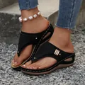 Detail of women's black wedge thong sandals with laser-cut patterns and metal buckle - 36 / Black