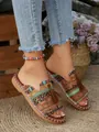 Detailed view of Bohemian flat sandals with ethnic patterns and tassels for summer. - Yellow