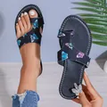 Close-up detail of women's ethnic black butterfly print toe-loop flat sandals for summer - 36 / Black Butterfly (Rhinestone Style)
